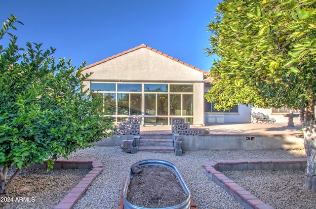 back of property with a patio