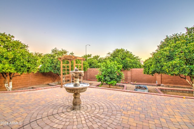 patio terrace at dusk with a pergola