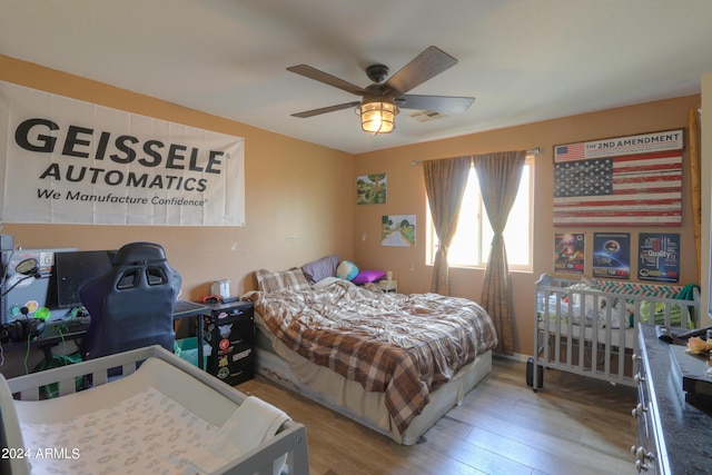 bedroom with ceiling fan and light wood-type flooring