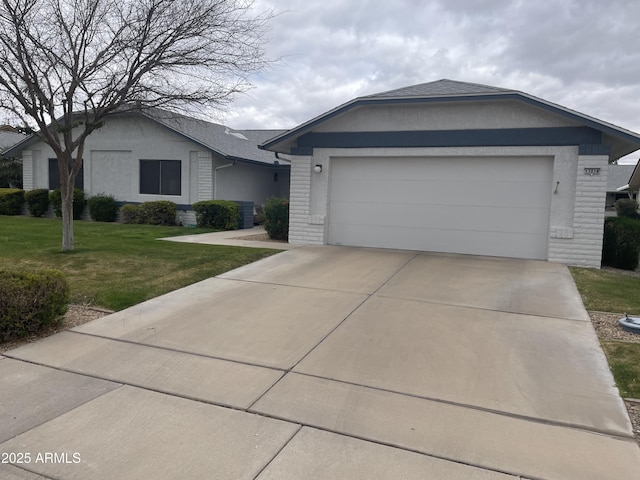 ranch-style home featuring a garage, a front yard, concrete driveway, and brick siding