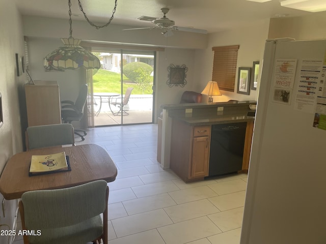 kitchen featuring a ceiling fan, freestanding refrigerator, and dishwasher