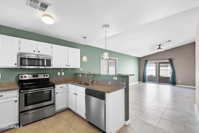 1120 N Val Vista Dr Unit 110, Gilbert, AZ 85234 - kitchen with appliances with stainless steel finishes, a sink, a ceiling fan, a peninsula, and light tile patterned floors