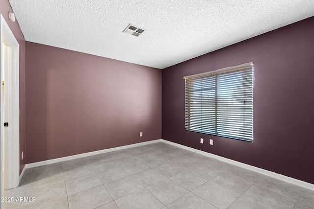 1120 N Val Vista Dr Unit 110, Gilbert, AZ 85234 - empty room featuring a textured ceiling, light tile patterned flooring, and baseboards
