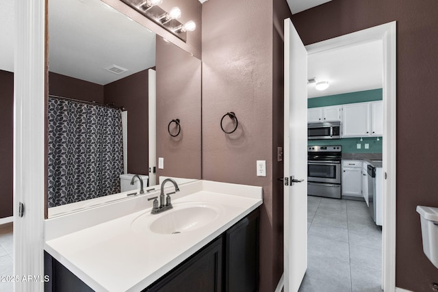 1120 N Val Vista Dr Unit 110, Gilbert, AZ 85234 - bathroom featuring tile patterned floors, vanity, and a textured wall
