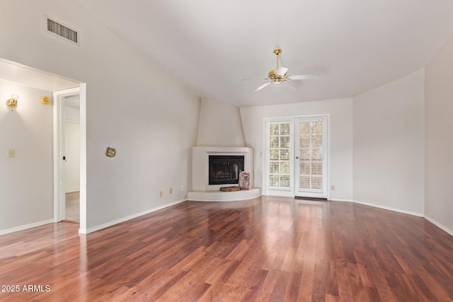 unfurnished living room featuring visible vents, baseboards, a fireplace, wood finished floors, and a ceiling fan