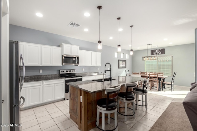 kitchen with visible vents, appliances with stainless steel finishes, a sink, and light tile patterned flooring