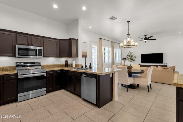 kitchen featuring light countertops, stainless steel appliances, open floor plan, and visible vents