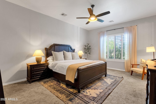 carpeted bedroom featuring baseboards, ceiling fan, and visible vents