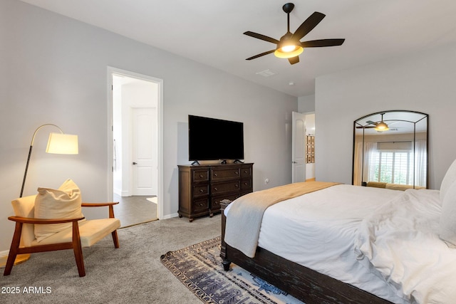 carpeted bedroom featuring baseboards, ceiling fan, and visible vents