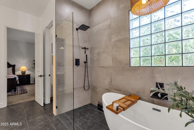 ensuite bathroom with a freestanding tub, tile walls, a walk in shower, tile patterned floors, and ensuite bathroom
