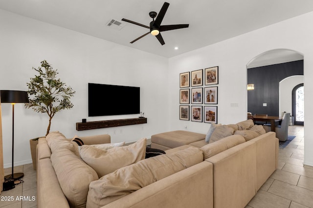 living room featuring visible vents, ceiling fan, recessed lighting, arched walkways, and light tile patterned floors