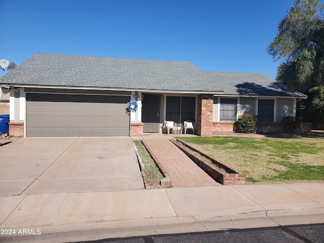 ranch-style home with a garage and a front yard