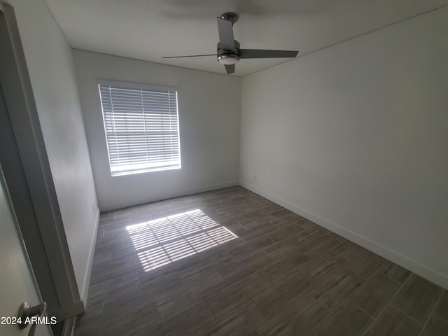 empty room with ceiling fan and dark hardwood / wood-style flooring