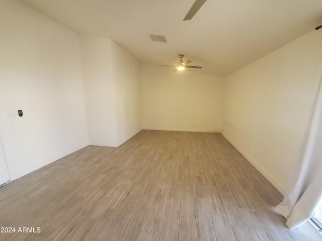 unfurnished room with ceiling fan and light wood-type flooring