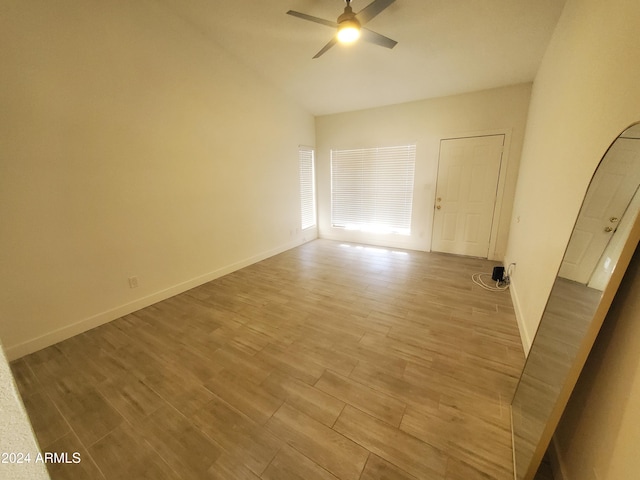 spare room with ceiling fan and light wood-type flooring