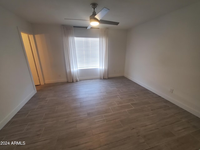 unfurnished room with dark hardwood / wood-style floors and ceiling fan