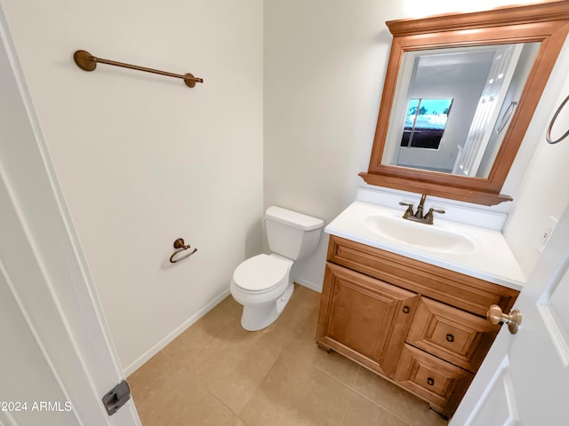 bathroom with tile patterned floors, toilet, and vanity