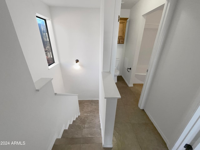 stairway with tile patterned floors