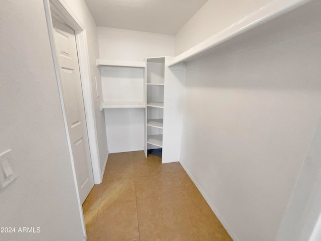 walk in closet featuring tile patterned flooring