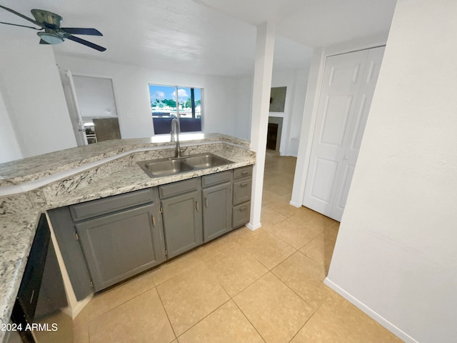 kitchen featuring gray cabinets, light tile patterned floors, sink, and ceiling fan