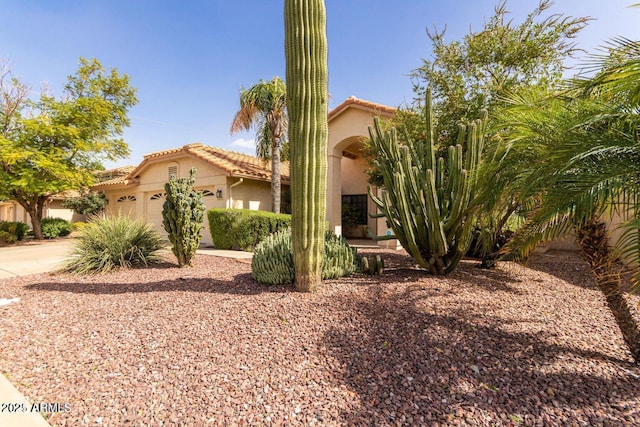 319 N Riata St, Gilbert, AZ 85234 - mediterranean / spanish home with a tiled roof, stucco siding, an attached garage, and driveway
