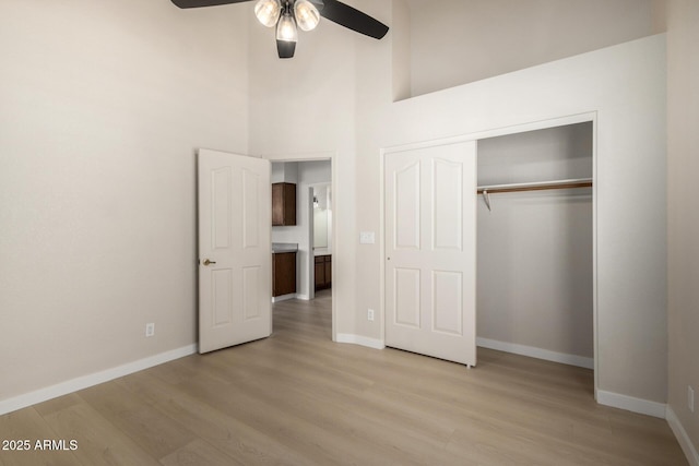 319 N Riata St, Gilbert, AZ 85234 - unfurnished bedroom with light wood-style flooring, a closet, ceiling fan, and a high ceiling