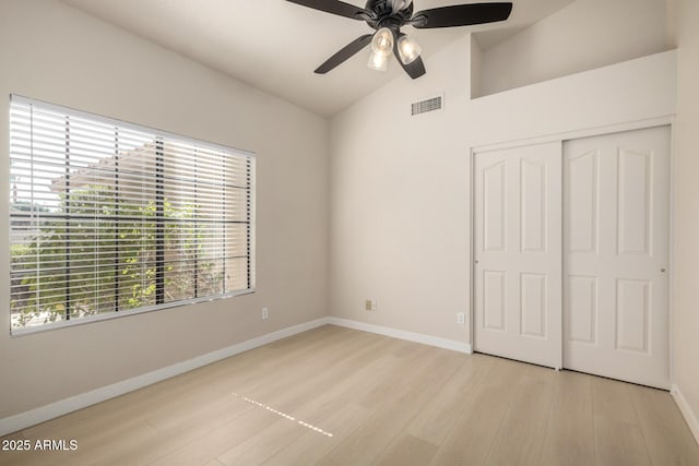 319 N Riata St, Gilbert, AZ 85234 - unfurnished bedroom featuring lofted ceiling, light wood-type flooring, a closet, and ceiling fan