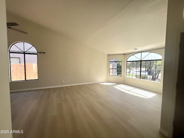 319 N Riata St, Gilbert, AZ 85234 - empty room with a ceiling fan, wood finished floors, and lofted ceiling