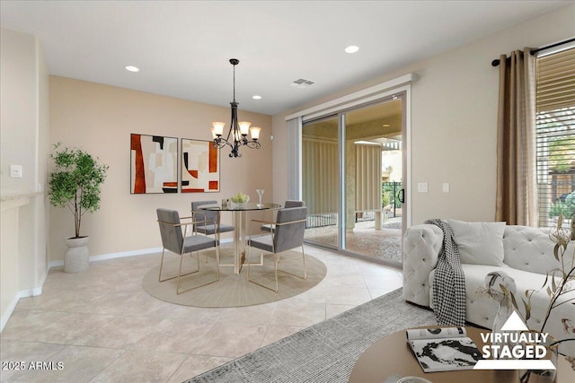 dining space featuring light tile patterned floors and a chandelier