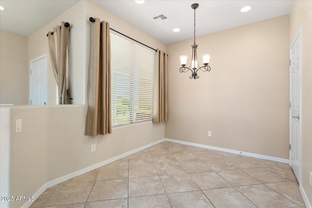 unfurnished room with an inviting chandelier and light tile patterned flooring