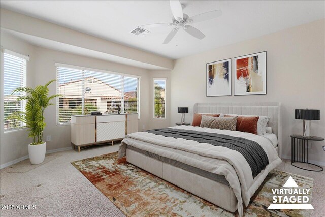 bedroom featuring multiple windows, carpet flooring, and ceiling fan