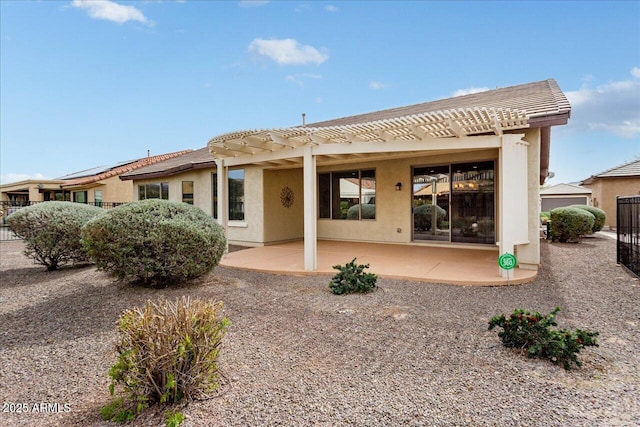 back of property featuring a pergola and a patio