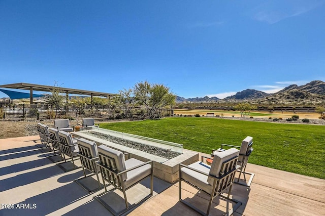 view of patio featuring a mountain view and a fire pit