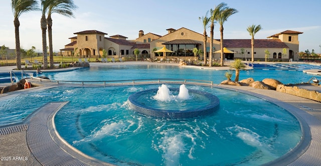 view of swimming pool with pool water feature