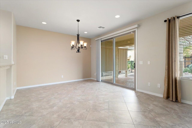 spare room with a chandelier