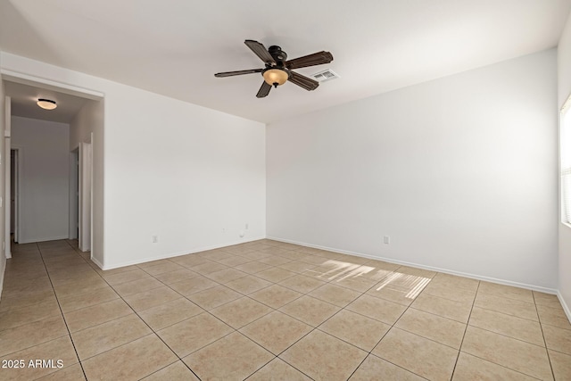 tiled empty room featuring ceiling fan