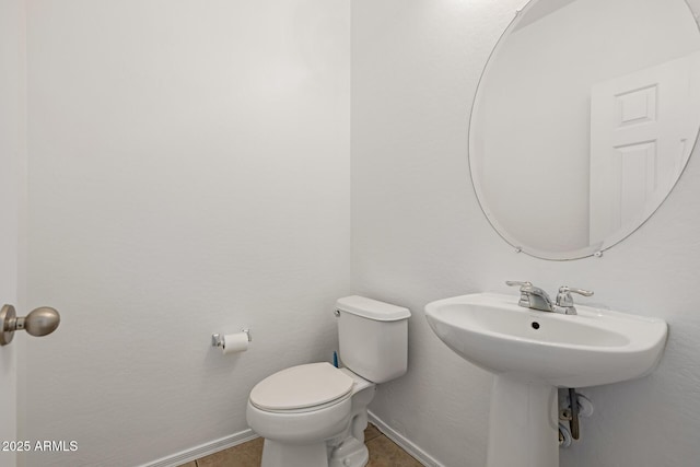 bathroom featuring tile patterned floors and toilet