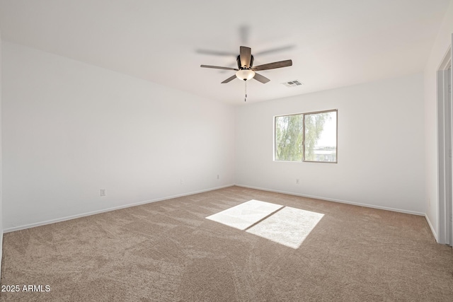 spare room featuring light carpet and ceiling fan