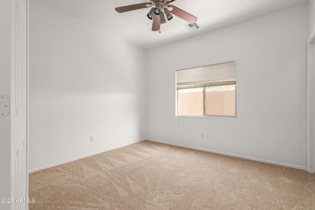 spare room with ceiling fan and light colored carpet