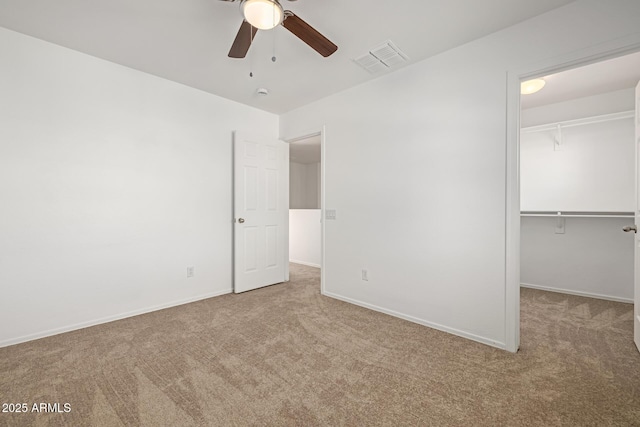 unfurnished bedroom featuring ceiling fan, a closet, and light carpet