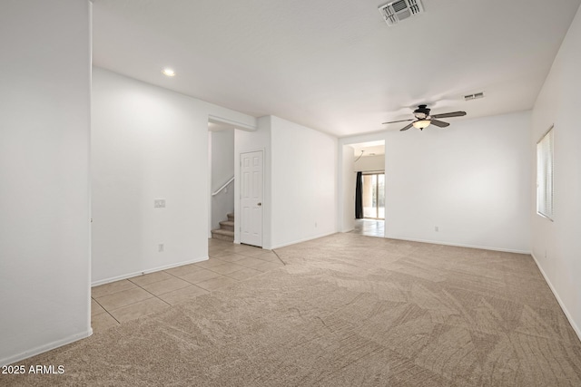 carpeted spare room with ceiling fan