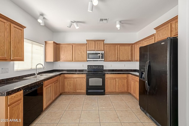 kitchen featuring sink, black appliances, and light tile patterned flooring