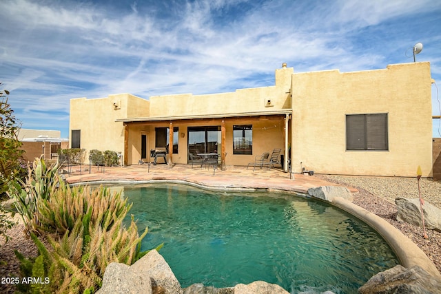 view of swimming pool with a patio