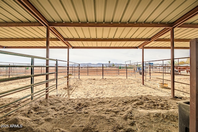 view of horse barn with a rural view