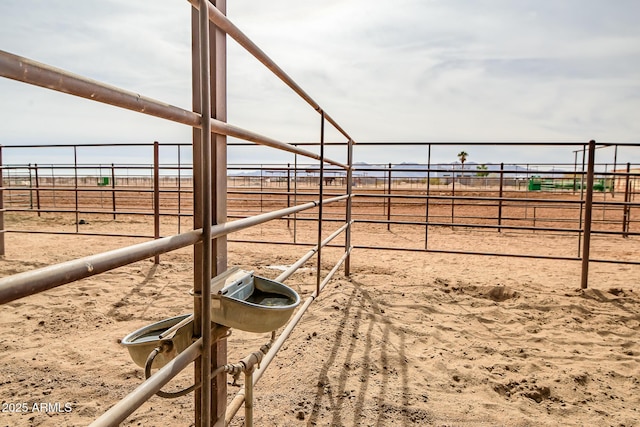 view of yard with a rural view and an outdoor structure