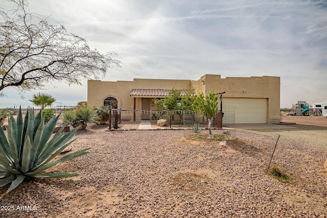 pueblo-style house with a garage