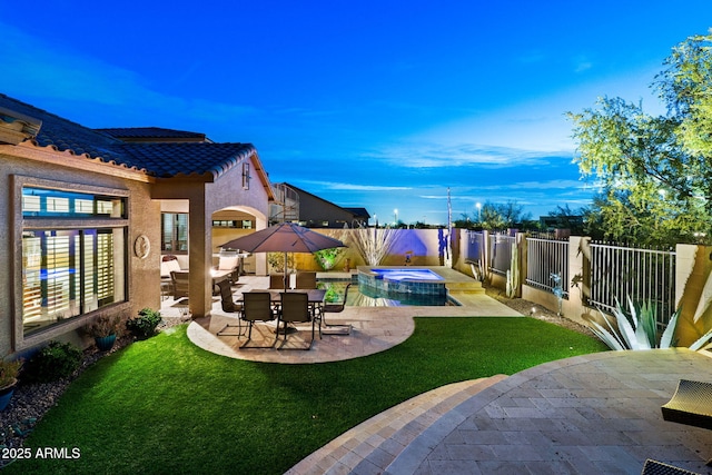 yard at dusk with a pool with hot tub and a patio area