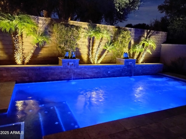 28831 N 128th Dr, Peoria, AZ 85383 - pool at night with a fenced backyard