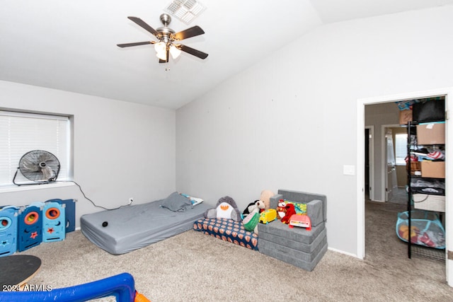 playroom with ceiling fan, light colored carpet, and vaulted ceiling