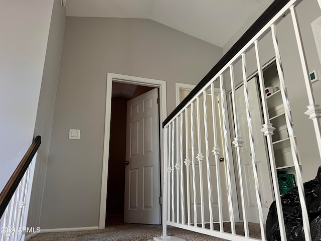 stairs with lofted ceiling and carpet floors